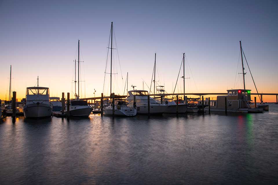Boats and bridge at sunset